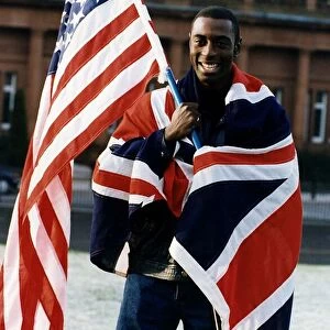 Tony Jarrett athlete runner with American and British flags at Kelvin Hall Glasgow