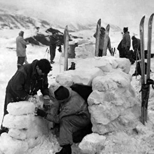 Troops busy cutting out the ice blocks and building the igloos which each houses two men