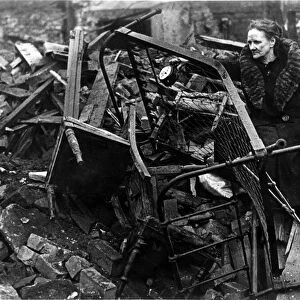 A victim of the blitz in Stafford Street, Bedminster, salvages some of the family