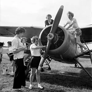 W. J. A. C. girls seen here servicing plane. August 1952 C4029