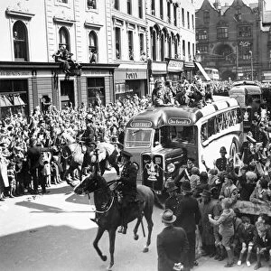 Wolverhampton Wanderers players show the FA Cup trophy to their fans from atop an open