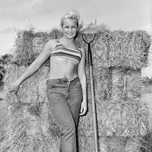 Woman modelling beachwear in a field during harvest