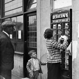 A woman seen here using the Automatic Fish and Chip dispenser at Redfern