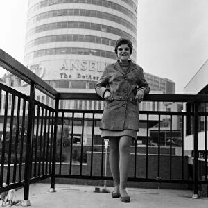 A woman standing in front of the Rotunda in Birmingham, West Midlands. 4th October 1967