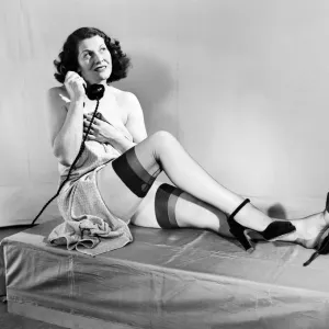 Woman wearing stockings seen here on the telephone. 1959