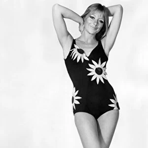 Woman wearing swimsuit with a pattern of yellow flowers, cut out in cotton