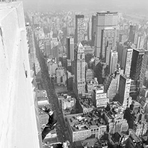 Workmen busy cleaning windows 1000 ft up the Empire State building in Manhatten New York