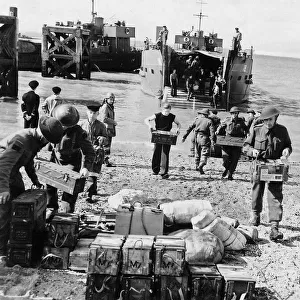 WW2 - Troops unload supplies from a landing craft on to British soil after a raid
