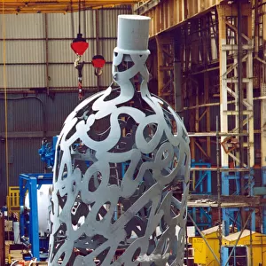 Yard electrician Peter Gilpin is dwarfed by the huge 35 foot metal bottle ordered by