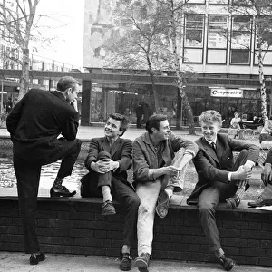 Young lads gather around the fountain in Stevenage Town Centre, Hertfordshire