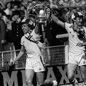 Young seventeen years old Paul Allen (right) leads the way with the FA Cup after West Ham