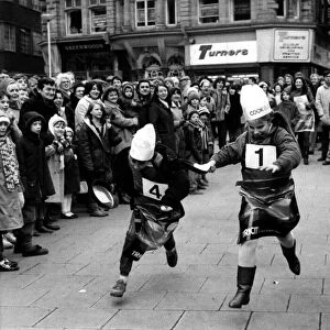Two youngsters battle it out in the Shrove Tuesday Pancake race at Grey