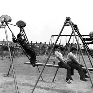 Four youngsters enjoying the Summer sunshine at a play area in the Cardiff docks area