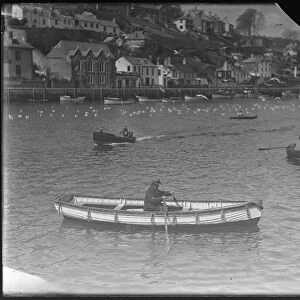 Motor boat on Looe River, passing West Looe Quay Rd