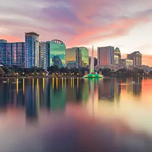 Orlando, Florida, USA downtown city skyline from Eola Park at dusk