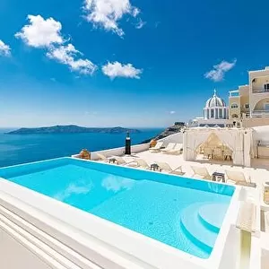 Romantic holidays Santorini resorts with infinity pool and sea view. Amazing summer travel landscape and white architecture, honeymoon destination