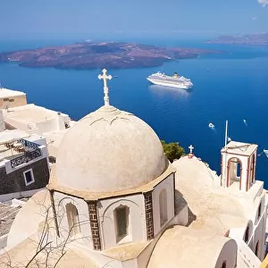 Thira (capital city of Santorini) - greek white church overlooking the cruise ship on Aegean Sea, Santorini Island, Greece