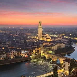 Verona, Italy town skyline on the Adige River at dusk
