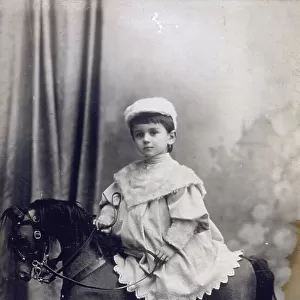Full-length portrait of a little girl on a rocking horse
