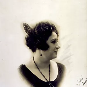 Half-length portrait of a lady in profile with a barette, earrings and a necklace