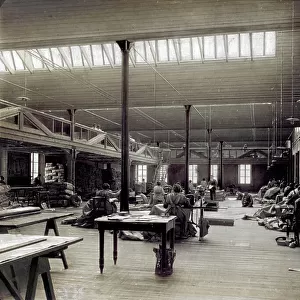 Interior room of the milanese plant of Tende Moretti, with the workers in charge of the sewing machines. In the room tables, lamps and fabrics to be worked can be seen