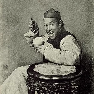 Portrait of a young Chinese man eating rice