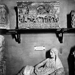 Detail of a room in Florence's Archaeological Museum with an Etruscan sarcophagus lid depicting a reclining female figure. The Archaeological Museum, Etruscan Wing, Florence