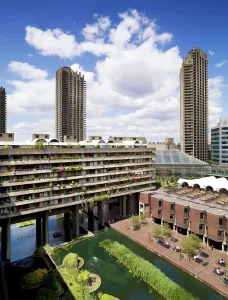 Prints of BARBICAN CENTRE, London. View of the brutalist architecture of the Barbican and flats that surround the centre. Listed Grade II (NHLE 1352667) Related Prints: Print of Barbican Centre, London: Brutalist Architecture