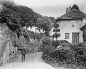 Prints of MANOR COTTAGE, WATER BAG BANK, KNARESBOROUGH, HARROGATE, NORTH YORKSHIRE. A view from the west showing a man walking up Water Bag Bank, past Manor Cottage Then and Now England - Historic Change Over Time: Early 20th-century photograph print of Water Bag Bank and Manor Cottage