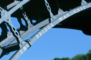 Prints of IRON BRIDGE, Shropshire. Detail of lettering on the famous cast iron bridge. Designed by Thomas Pritchard and built in 1779 by Abraham Darby III of the Coalbrookdale Company Engineering And Construction Prints: Iron Bridge Print - Detail of Cast Iron Lettering