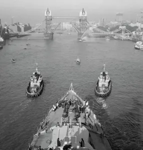 Prints of TOWER BRIDGE, Stepney, London. Looking down onto the foredeck of the cruiser HMS Belfast Iconic Photographers of England - Historic Image Collections: Print of HMS Belfast near Tower Bridge, London