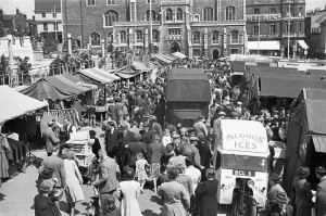 Prints of Norwich, Norfolk. The bustling marketplace. Photographed by Hallam Ashley in July 1948 Iconic Photographers of England - Historic Image Collections: Print of Norwich Market in 1948