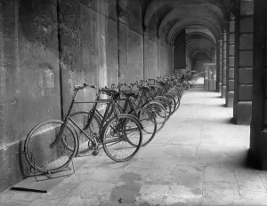 Prints of QUEENs COLLEGE, Oxford, Oxfordshire. A 1903 view looking west along the south arcade of the front quad with parked bicycles belonging to members of the college Iconic Photographers of England - Historic Image Collections: Print of Queens College Oxford, a 1903 view looking west