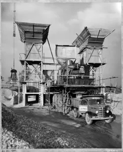 Prints of FILTON AIRFIELD, SOUTH GLOUCESTERSHIRE. A concrete batching plant, with a Laing truck being loaded in the foreground, at Filton Airfield during the construction of a new runway Engineering And Construction Prints: Concrete Batching Plant Print, Filton Airfield