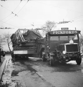 Prints of NEWCASTLE UPON TYNE. A Pickfords low loader transporting a W90 walking dragline excavator to Whitley Bay opencast coal site Engineering And Construction Prints: Print of a low loader transporting a W90 dragline excavator