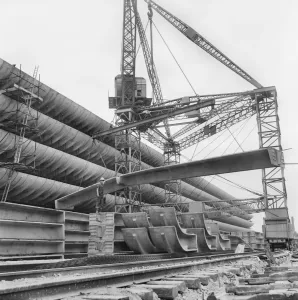 Prints of Preston Bus Station, Tithebarrn Street, Preston. The placement of a concrete beam during construction. Photographed in June 1969; John Laing Collection Engineering And Construction Prints: Print of Preston Bus Station construction with concrete beam placement