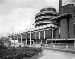 Prints of WOOD GREEN SHOPPING CITY, HARINGEY, GREATER LONDON. A view of the Mayes Road entrance to the Market Hall at Wood Green Shopping City, with the spiral ramps of the west car park rising above Engineering And Construction Prints: Wood Green Shopping City Print, Mayes Road entrance to the Market Hall