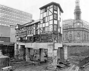 Prints of Old Wellington Inn, Old Shambles, Manchester. Exterior view of the Wellington Inn, Old Shambles, shown during the extensive surrounding building works, November 1971 Engineering And Construction Prints: Print of the Wellington Inn on stilts, Manchester