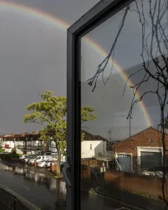 Prints of South Harrow, Harrow, Greater London. A residential street shortly after a cloud burst, with a rainbow in the sky Weather Prints: Rainbow Print, South Harrow Street Scene