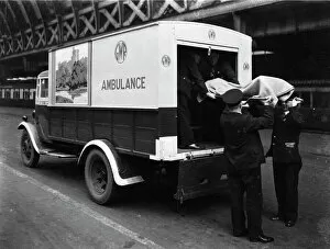 Accident Collection: GWR staff loading a stretcher into a parcel van which has been converted into an ambulance, 1940