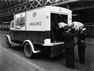 GWR staff loading a stretcher into a parcel van which has been converted into an ambulance, 1940 GWR staff loading a stretcher into a parcel van which has been converted into an ambulance, 1940