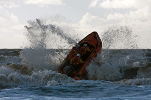 Blackpool D-class inshore lifeboat D-729 launching through a breaking wave Blackpool D-class inshore lifeboat D-729 launching through a breaking wave