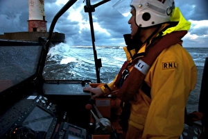 Coxswain stood at the helm of the Berwick-upon-Tweed Mersey class lifeboat Joy and Charles Beeby 12-32, lots of spray Coxswain stood at the helm of the Berwick-upon-Tweed Mersey class lifeboat Joy and Charles Beeby 12-32, lots of spray