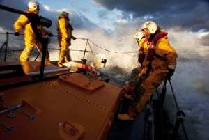 Crew members stood at the bow of the Berwick-upon-Tweed Mersey class lifeboat Joy and Charles Beeby 12-32 Crew members stood at the bow of the Berwick-upon-Tweed Mersey class lifeboat Joy and Charles Beeby 12-32