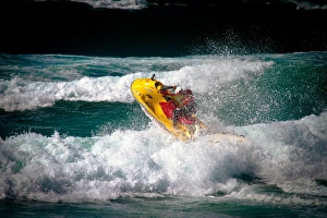 Lifeguard on a rescue watercraft (RWC) in the surf at Perranporth beach, Cornwall Lifeguard on a rescue watercraft (RWC) in the surf at Perranporth beach, Cornwall