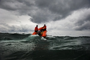 Two lifeguards on an arancia inshore rescue boat at Watergate Bay Two lifeguards on an arancia inshore rescue boat at Watergate Bay