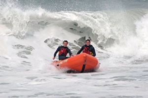 Two lifeguards on an arancia IRB in surf at St Agnes Two lifeguards on an arancia IRB in surf at St Agnes