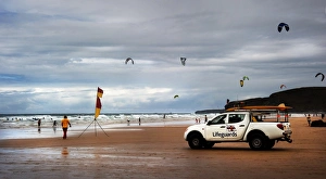 Lifeguards monitoring the beach from a patrol vehicle Lifeguards monitoring the beach from a patrol vehicle