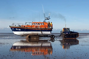 Lytham St Annes Mersey class lifeboat Her Majesty the Queen 12-30 being recovered by tractor on the beach after an Lytham St Annes Mersey class lifeboat Her Majesty the Queen 12-30 being recovered by tractor on the beach after an