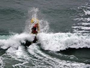 An RNLI lifeguard on a rescue water craft at Perranporth An RNLI lifeguard on a rescue water craft at Perranporth